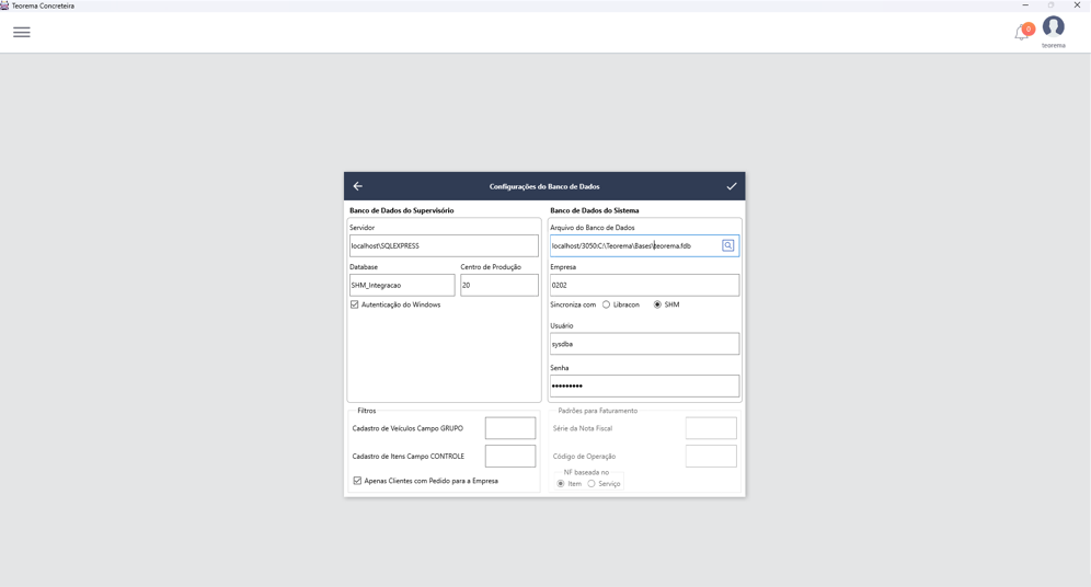 Diálogo Configurações do Banco de Dados com seção "Banco de Dados do Supervisório" — campos Servidor (localhost\SQLEXPRESS), Database (SHM_Integracao), Centro de Produção (20), checkbox Autenticação do Windows marcado — e seção "Banco de Dados do Sistema" — campo Arquivo do Banco de Dados (localhost/3050/C:\Teorema\Bases\teorema.fdb), Empresa (0202), opção Sincroniza com SHM selecionada, campos Usuário (sysdba) e Senha