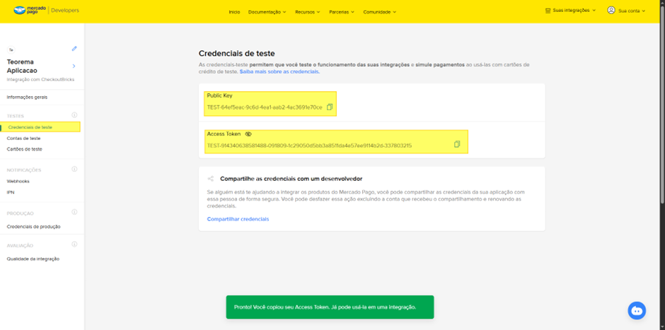 Tela "Credenciais de teste" do Mercado Pago Developers com campos "Public Key" e "Access Token" exibindo valores de ambiente de teste, ícones de cópia ao lado de cada campo e seção "Compartilhe as credenciais com um desenvolvedor" com link "Compartilhar credenciais"